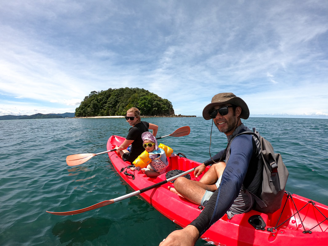 Family kayaking to Pandan Island at Bigfin beach resort Sabah Borneo